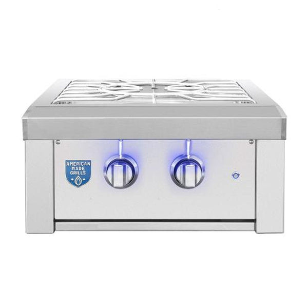 Stainless steel outdoor power burner with sturdy grates, dual blue-illuminated control knobs, and a sleek modern design.