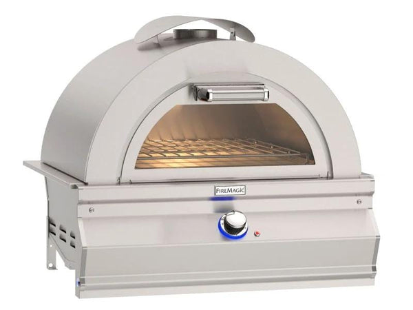 Stainless steel outdoor pizza oven with domed top, front glass window, interior cooking rack, and control knob with blue light.