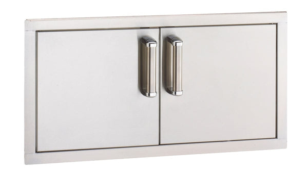 Stainless steel double access doors with sleek vertical handles, designed for outdoor kitchen storage and built-in grill island setups.