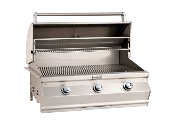 Open stainless steel built-in gas grill with three control knobs, large cooking surface, and upper warming rack for versatile outdoor grilling.
