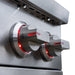 Close-up of stainless steel control knobs illuminated with red LED lighting on a modern outdoor grill for heat control.
