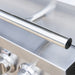 Close-up of stainless steel grill showing sturdy tubular handle and polished control knobs.