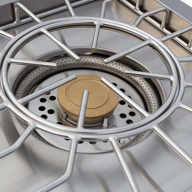 Close-up of a stainless steel outdoor burner with a brass burner surrounded by durable, polished grates for stability and heat distribution.