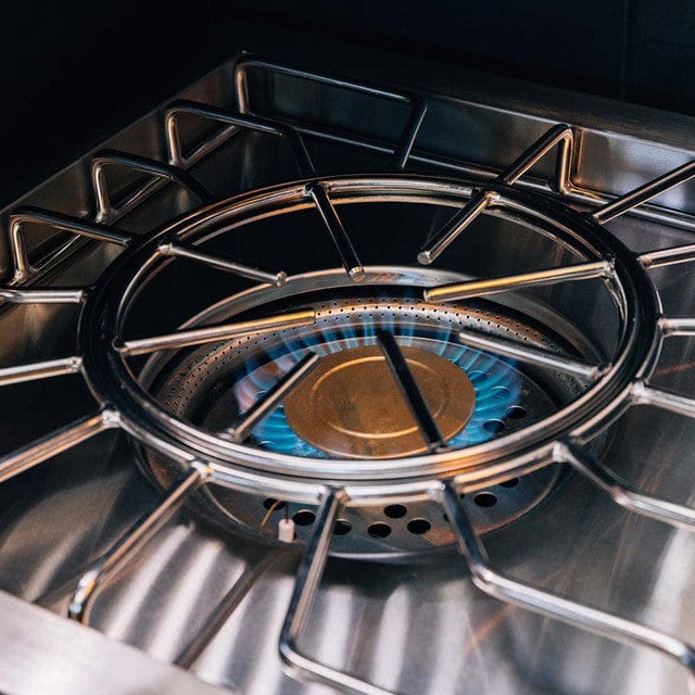 Close-up of a stainless steel outdoor burner with a brass burner and blue flame, surrounded by polished, sturdy grates.