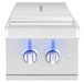 Stainless steel outdoor side burner with closed lid, dual blue-illuminated control knobs, and a modern, compact design.