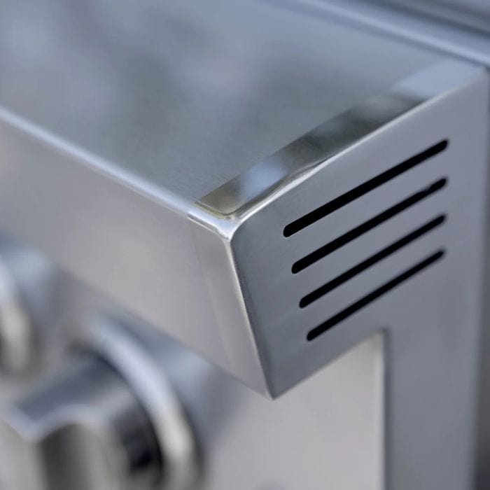 Close-up of a stainless steel grill corner with ventilation slots and a sleek, polished design showcasing durability and craftsmanship.