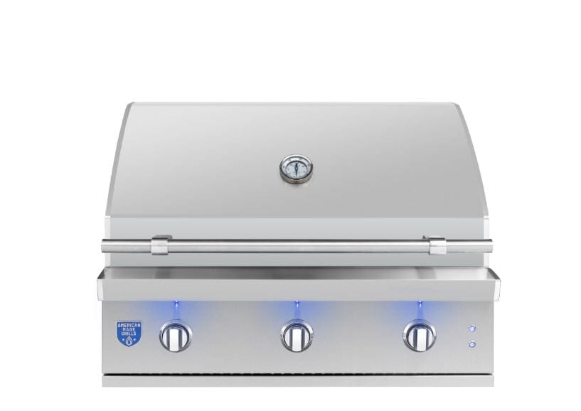 Stainless steel built-in grill with three control knobs, a thermometer on the lid, and LED-lit knobs, designed for outdoor cooking.