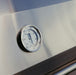Close-up of a built-in thermometer on a stainless steel grill lid, displaying precise temperature measurements for outdoor cooking.