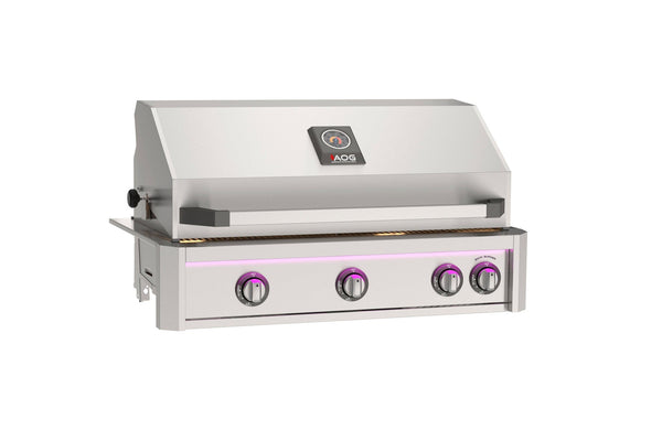 Stainless steel built-in gas grill with hood, temperature gauge, and purple illuminated control knobs designed for outdoor kitchen islands.
