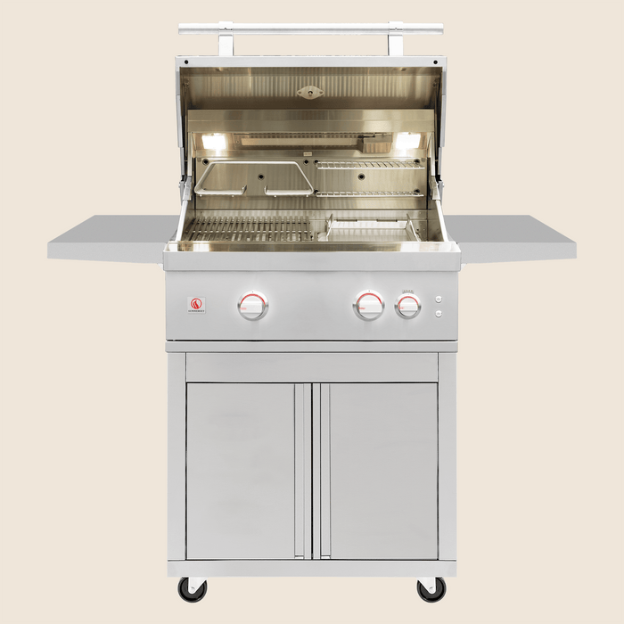 Stainless steel outdoor gas grill with open hood, illuminated cooking area, side shelves, and storage cabinet on caster wheels.