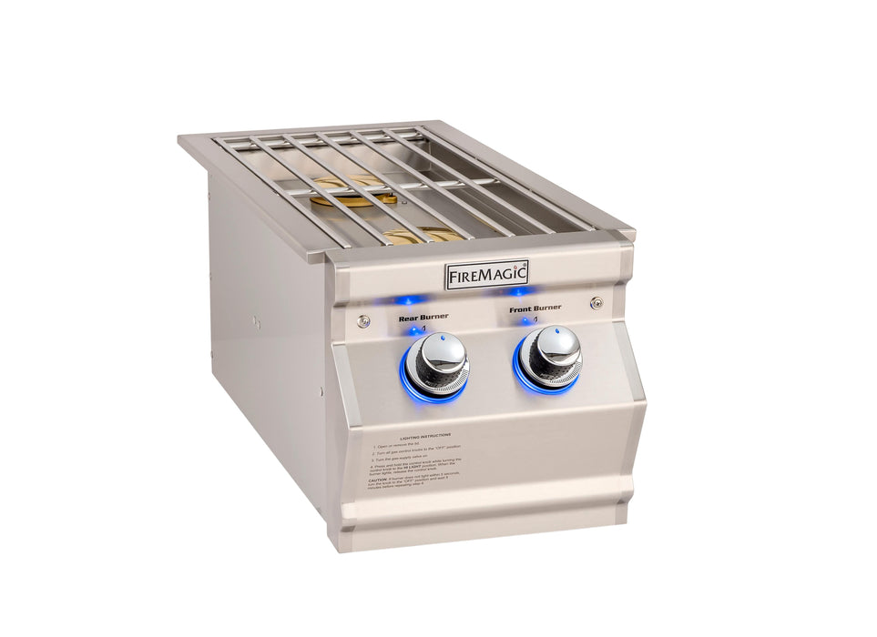 Stainless steel double side burner with illuminated control knobs, protective grate, and two brass burners for versatile outdoor cooking.