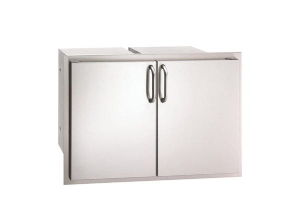 Stainless steel double access doors with sleek curved handles, designed for outdoor kitchen storage and easy access to grilling supplies.