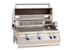 Open stainless steel gas grill with rotisserie kit, warming rack, interior lights, and blue LED-lit control knobs for outdoor cooking.