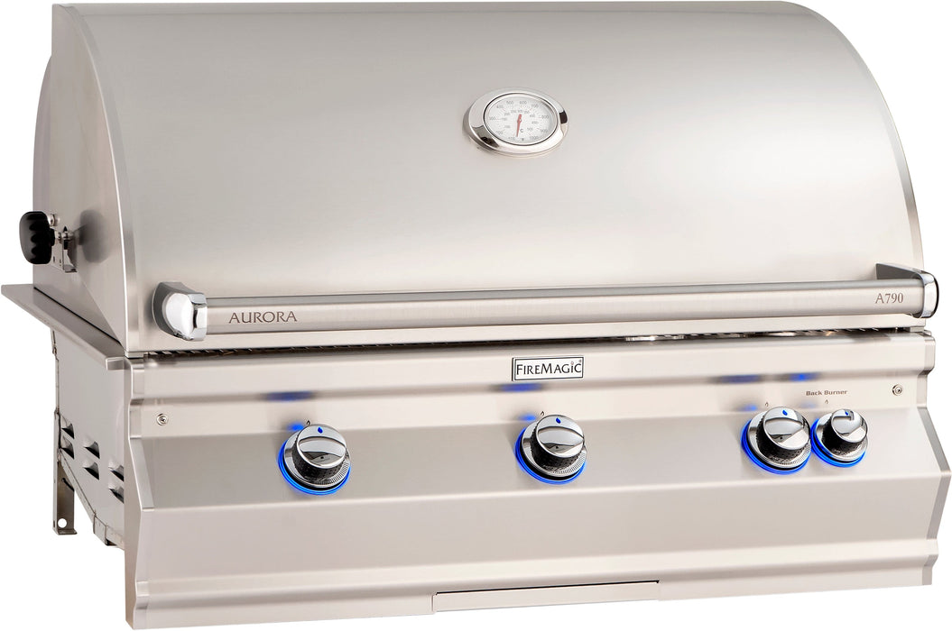 Large stainless steel built-in gas grill with curved lid, built-in thermometer, and four blue LED-lit control knobs for outdoor cooking.