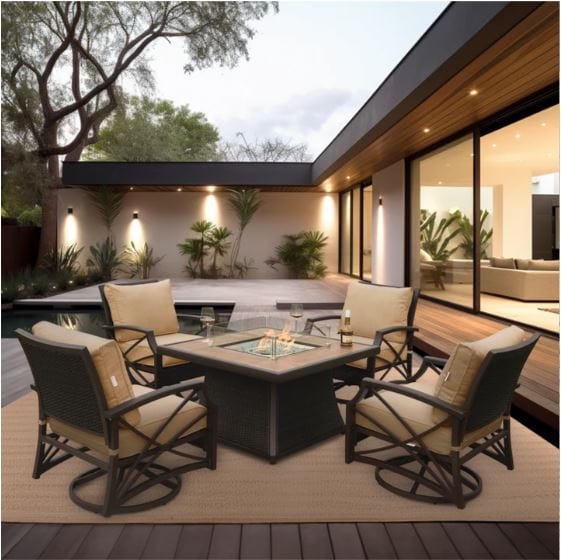 A square fire pit table with a glass enclosure, surrounded by tan color cushioned chairs on a patio with a pool in the background.