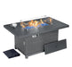 Rectangular outdoor fire pit table with a glass wind guard, blue fire glass, a wicker base, side access panel, and included cover.