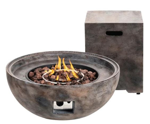 Round concrete fire pit with a sleek finish, featuring lava rocks and a visible burner flame, accompanied by a matching propane storage table.