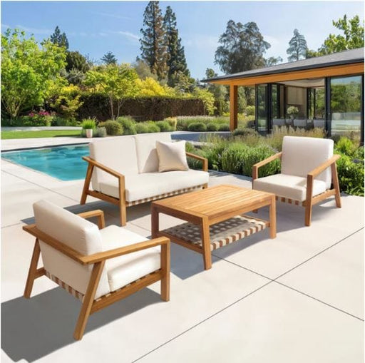 Modern outdoor patio furniture set with teakwood chairs, loveseat, and coffee table, featuring cream cushions, poolside and lush garden setting.