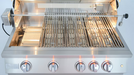 Stainless steel gas grill with wide cooking grates, built-in rotisserie, interior lighting, and five illuminated control knobs for precision grilling.