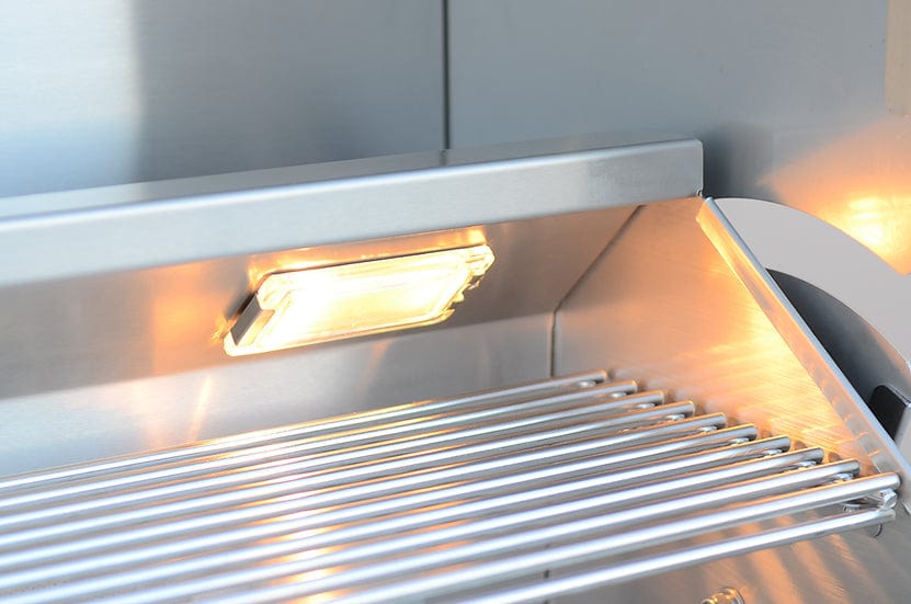 Close-up of an illuminated stainless steel warming rack inside a built-in gas grill, showcasing an integrated internal light