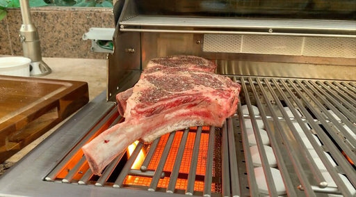 Infrared sear burner grilling a thick bone-in steak, showcasing high heat for perfect searing and creating a caramelized, flavorful crust