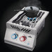 Stainless steel double burner with wavy grill grates, blue flame, red and blue-lit knobs, and a black pot placed on one burner.