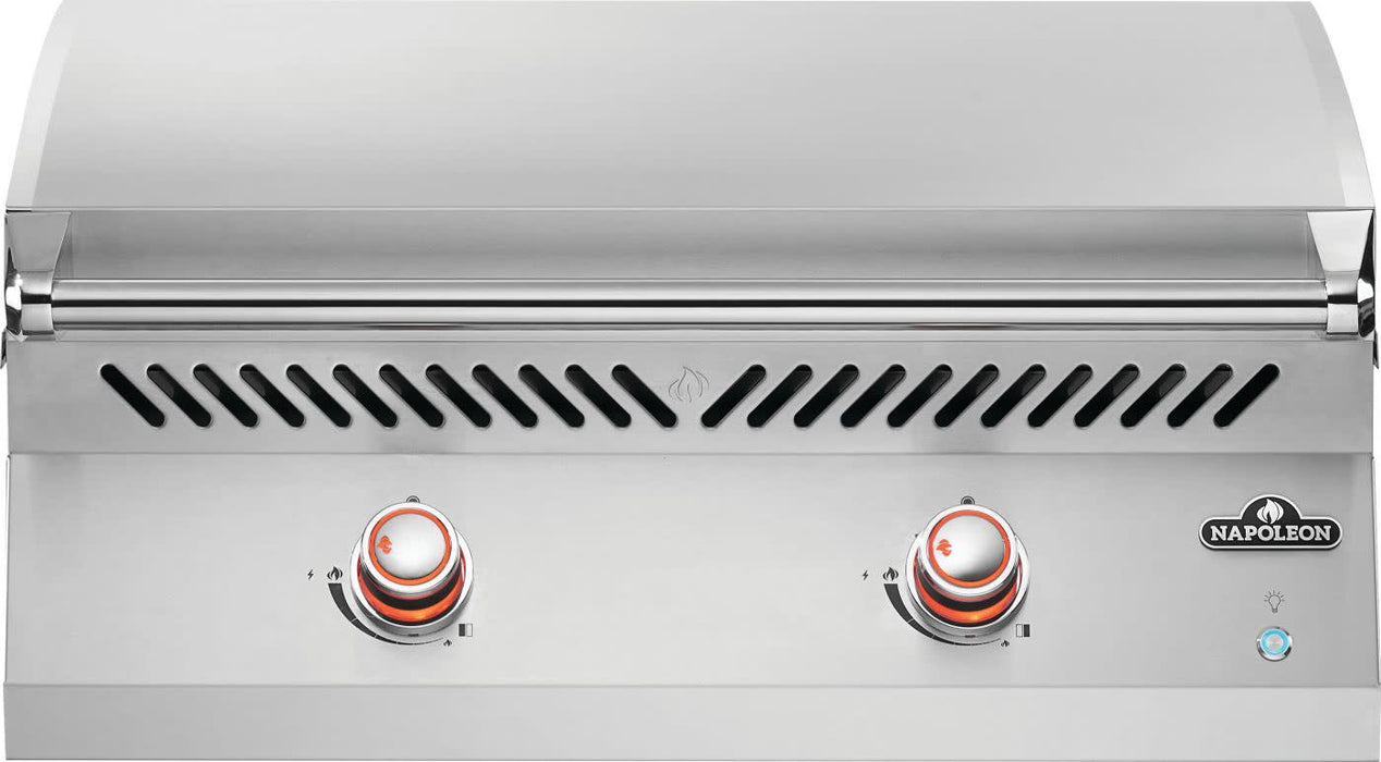 Stainless steel outdoor griddle with a closed lid, vented design, and two red-lit control knobs for precise heat adjustment.