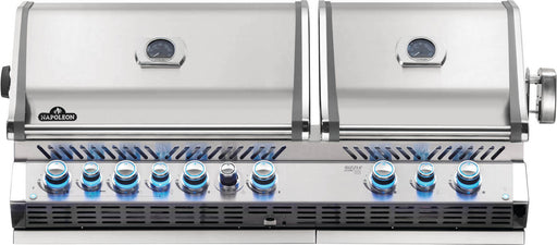 Stainless steel dual-lid built-in gas grill with blue-lit control knobs, two thermometers, and a vented design for versatile cooking options.