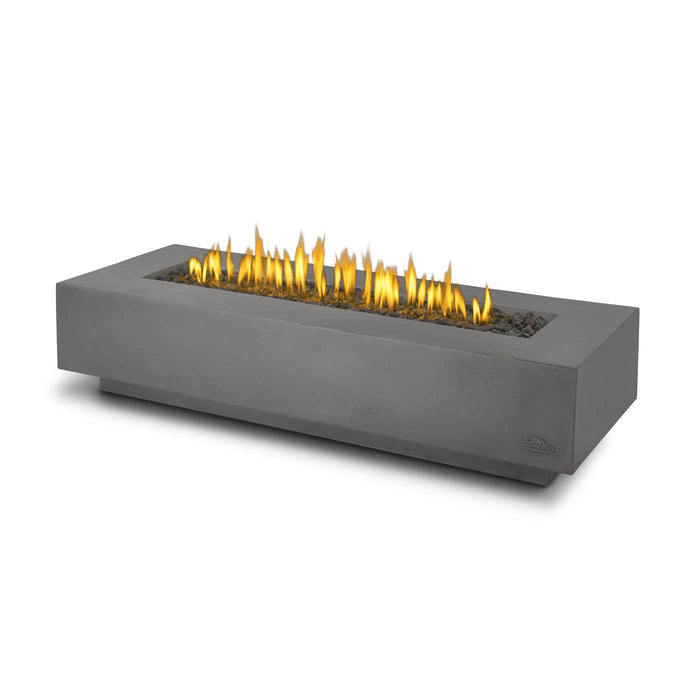 Modern rectangular concrete fire pit with a smooth finish, featuring tall, bright yellow flames surrounded by decorative stones.