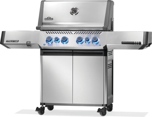 Stainless steel freestanding grill with illuminated knobs, dual storage doors, side shelves, caster wheels, and temperature gauge.