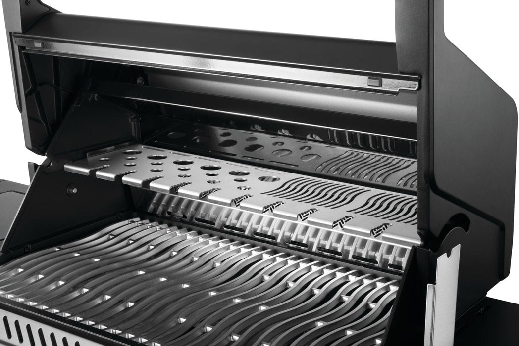 Open grill showcasing stainless steel cooking grids, perforated warming rack, and sleek black interior design for optimized grilling.