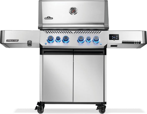 Front view of a stainless steel grill with a closed lid, illuminated blue control knobs, double cabinet doors, and side shelves.