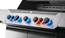 Close-up of illuminated control knobs on a stainless steel outdoor grill, with blue and red lighting indicating active burners.