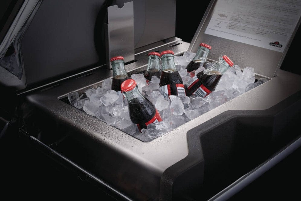 Built-in ice bucket filled with ice and glass soda bottles, integrated into a stainless steel grill, perfect for outdoor entertaining