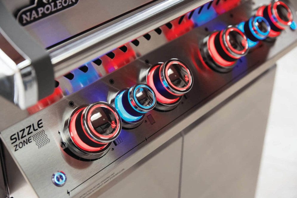 Close-up of illuminated control knobs on a stainless steel gas grill, featuring vibrant red and blue LED lights for style and functionality