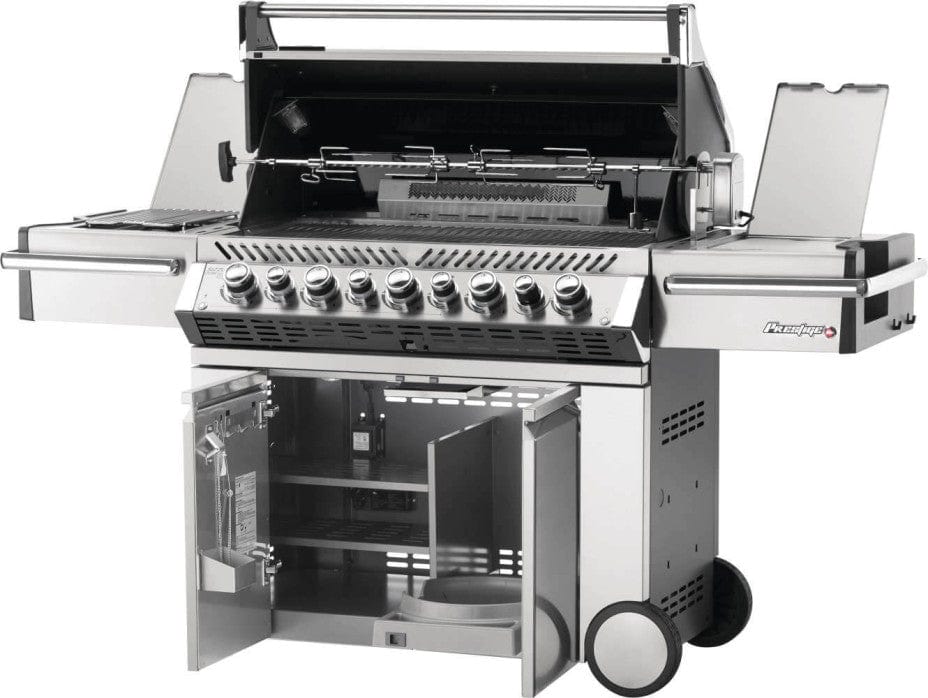 Open view of stainless steel gas grill with open hood showing rotisserie setup, side burners, control knobs, and open cabinet storage below