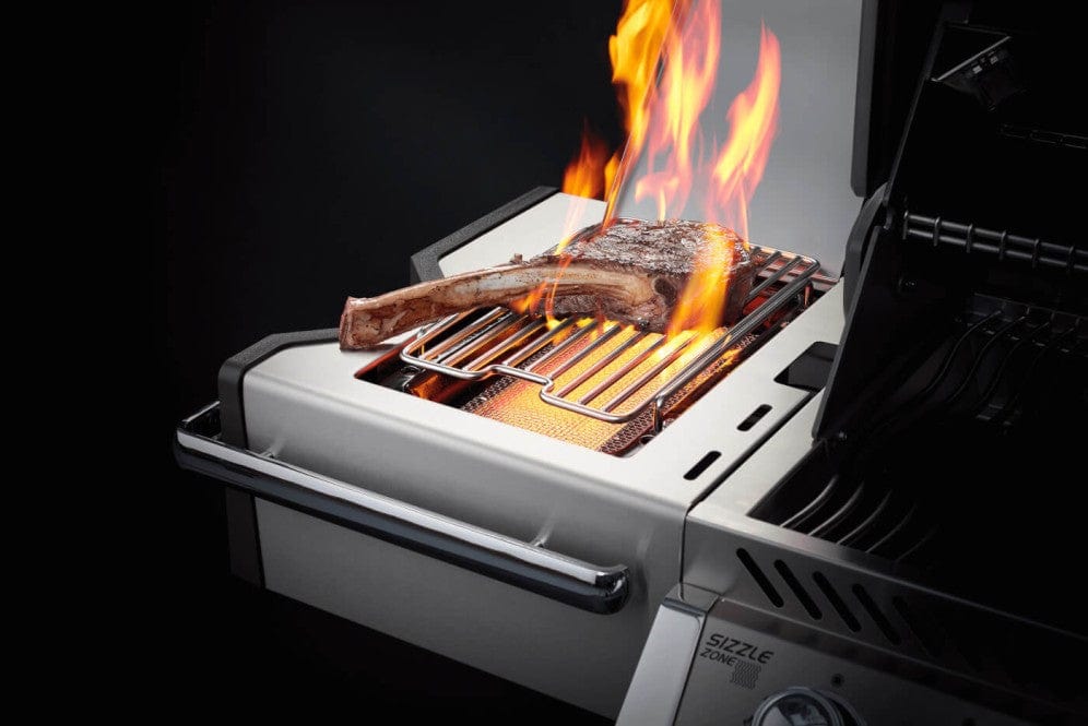 Infrared side burner grilling a tomahawk steak with high flames, showcasing intense heat for perfect searing on a stainless steel grill