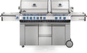 Large stainless steel outdoor grill with two separate lids, multiple burners with blue-lit control knobs, side burners, and storage cabinets