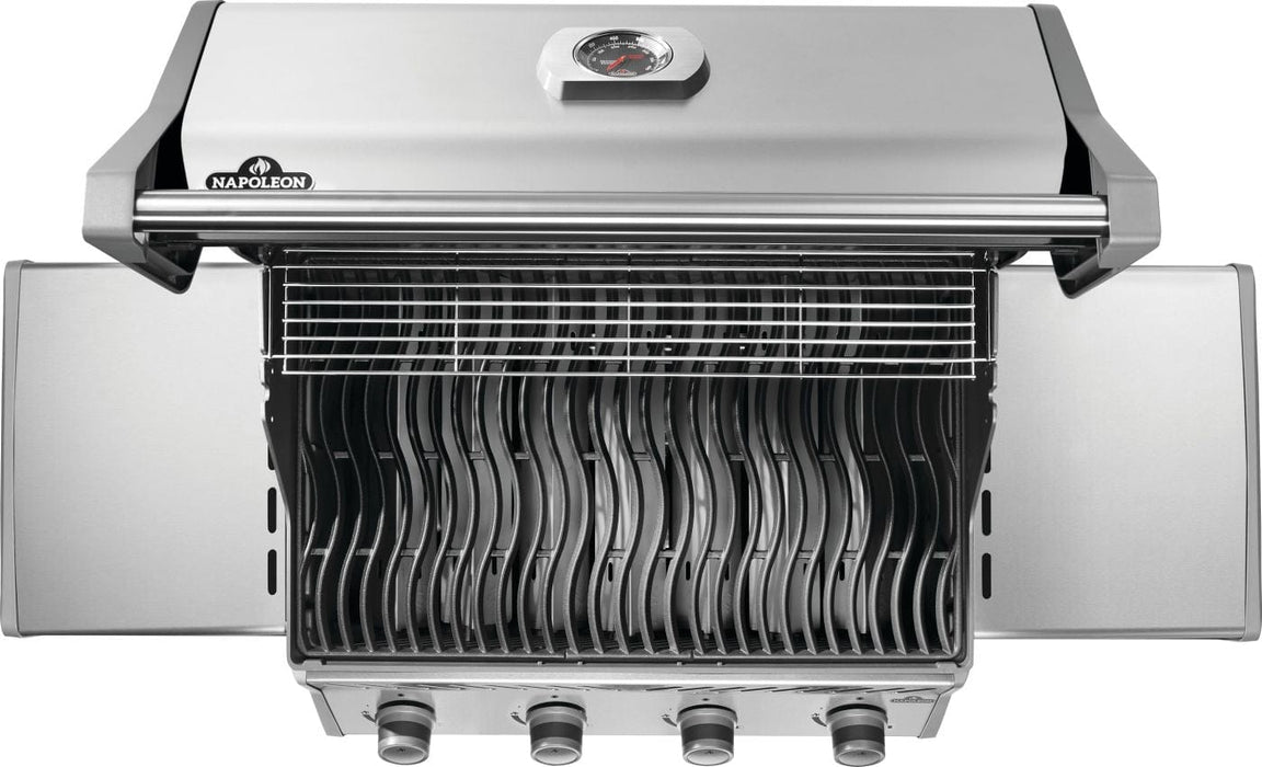 Top view of an open stainless steel grill with wavy cooking grates, an elevated warming rack, and foldable side shelves.