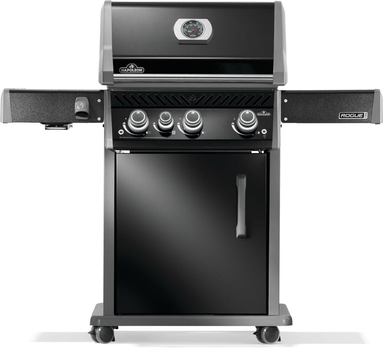 Front view of a black grill with a closed lid, four control knobs, a cabinet base, and foldable side shelves on caster wheels.