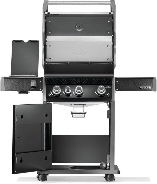 Open grill showing the interior cooking area with a warming rack, four control knobs, a cabinet door ajar, and a side burner on the left.