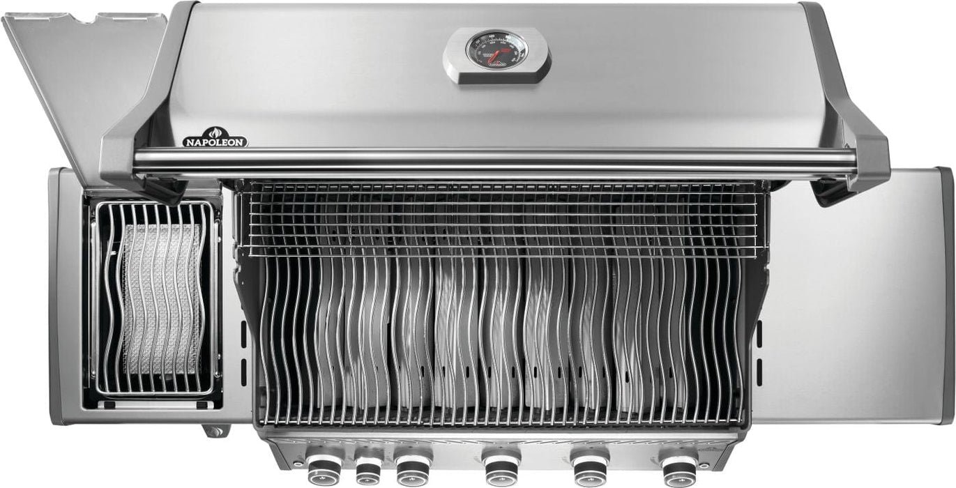 Top view of a stainless steel grill with wavy cooking grates, warming rack, infrared side burner, and six control knobs below.