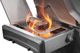 Side burner with an open lid grilling a steak over intense flames on a stainless steel grate, showcasing high heat cooking.