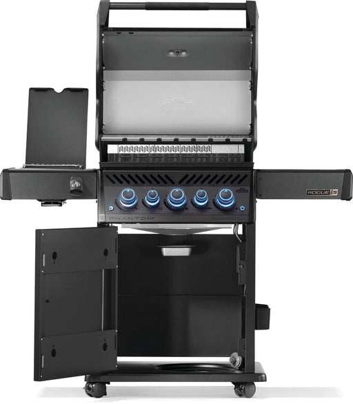 Black freestanding grill with open hood revealing cooking grates, side shelves, illuminated knobs, and a storage cabinet with open doors.