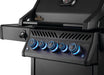 Close-up of a black grill control panel with five illuminated blue knobs, sleek design, and a side burner control feature.