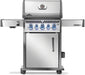 Stainless steel gas grill with illuminated control knobs, closed storage cabinet, and side shelves, shown on caster wheels.