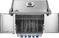 Top view of a stainless steel grill with wavy cooking grates, a warming rack, control knobs, and side panels for food preparation.