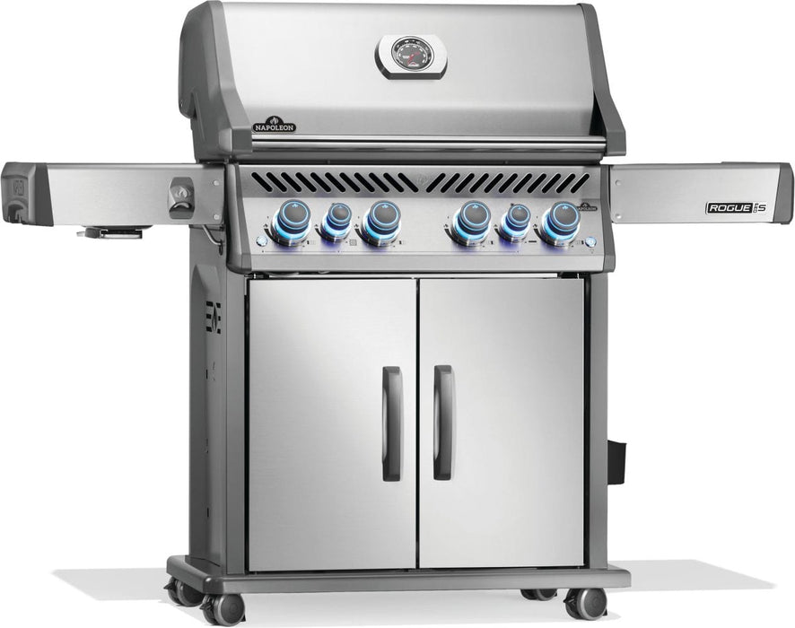 Stainless steel barbecue grill with illuminated control knobs, double-door storage cabinet, side shelves, and built-in thermometer.