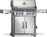 Stainless steel barbecue grill with illuminated control knobs, double-door storage cabinet, side shelves, and built-in thermometer.