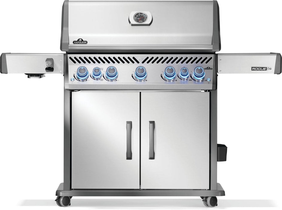 Stainless steel grill with illuminated control knobs, two cabinet doors, side shelves, and a temperature gauge on the lid.